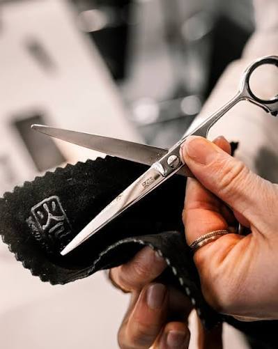 Wiping scissor blades with a leather cloth
